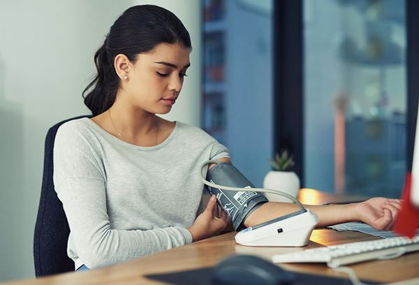 woman taking blood pressure at work